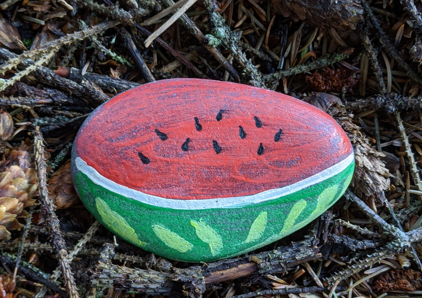 Painted rock that looks like a watermelon slice